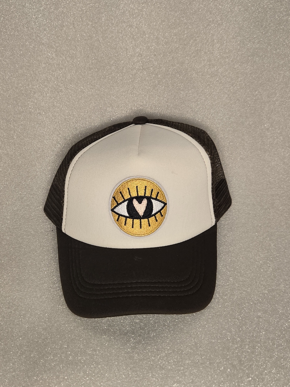 Adult Black and White Trucker Hat with Yellow Eye Patch